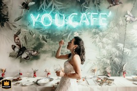 Profile shot of the bride eating inside You Café during the aperitif in Forlì, Italy.